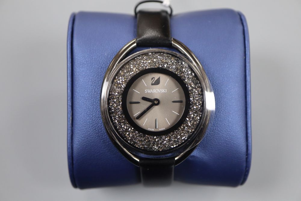 A modern stainless steel Swarovski wristwatch, with box.